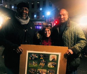 Pittsburgh Steelers legends Franco Harris and Joe Greene visit with Linda Barnicott at the Holiday Market in Market Square.