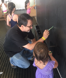 Tom Barnicott, husband of Linda Barnicott, spends time with his granddaughter, Aria, at the Children's Museum.