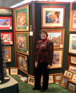 Linda Barnicott, Pittsburgh's Painter of Memories, poses in her booth at the Pittsburgh Home and Garden Show.