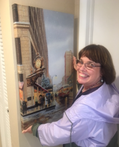 Linda Barnicott, Pittsburgh's Painter of Memories, hangs a large canvas reproduction of her painting "Waiting for You Under Kaufmann's Clock."