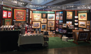 This photo features the Pittsburgh Home and Garden Show booth of Linda Barnicott, Painter of Memories.