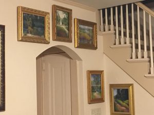 This photo features some of Linda Barnicott's landscapes hung above a door.