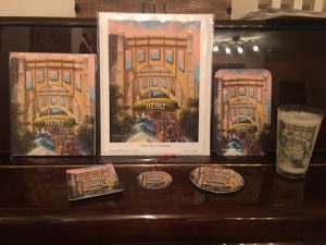 This image features the different products available with Linda Barnicott's new painting "Pickle Fun In Pittsburgh": print, borderless 8x10, sandwich tray, mint tray, ornament, coaster, and pint glass.