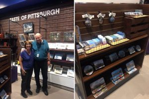 Two photos: one of Linda Barnicott in one of the stores at the Pittsburgh International Airport. The second photo features her work displayed at a store in the Pittsburgh International Airport.