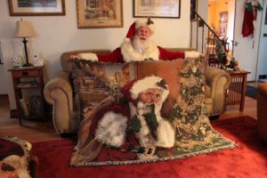 Santa Claus holding Linda Barnicott's new throw blanket that features her "Shhhh!" painting.