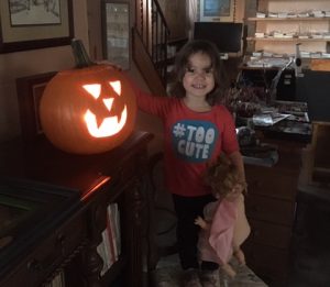 This image shows Aria, granddaughter of Linda Barnicott, with a pumpkin she carved.