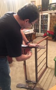 Linda Barnicott's husband, Tom, constructs a bin for her Second Annual Studio Open House and Trunk Show taking place November 15th, 16th, and 17th