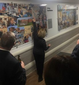 In this image, Linda Barnicott points out different features of her murals lining the walls of Forbes Hospital in Monroeville, Pennsylvania.