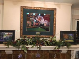 This image shows Linda Barnicott's original painting "All Aboard with Santa" above the mantel in her home.
