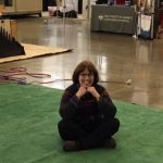 The image is of Linda Barnicott sitting down at the Pittsburgh Home and Garden Show.