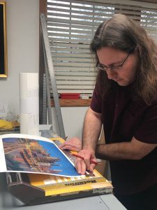 Alex Patho, printer, works on Linda Barnicott's new painting "Pittsburgh's Tunnel Vision."