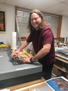 Alex Patho, printer, works on Linda Barnicott's new painting "Pittsburgh's Tunnel Vision."